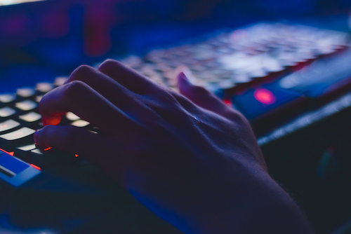 hands typing at keyboard